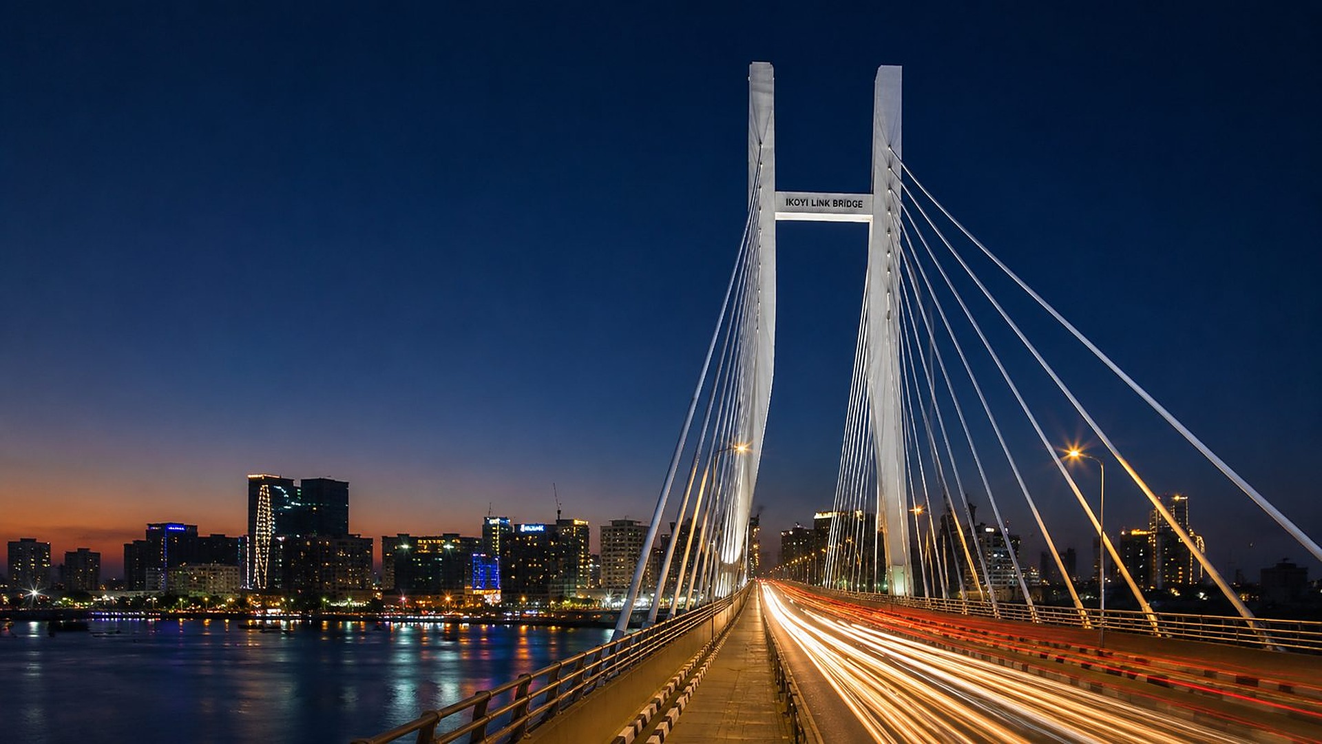 Ikoyi Link Bridge at night with Lagos skyline and light trails